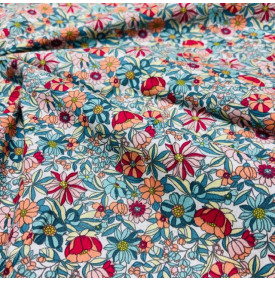 Coton imprimé Apolline corail, motif floral dense et lumineux.