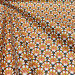 Coton enduit imprimé terracotta au motif Art Déco graphique, tissu imperméable léger et souple