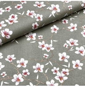 Coton enduit imprimé fleurs d’amandier sur fond vert sauge